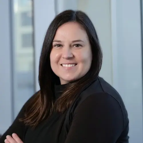 a woman with long brown hair wearing black shirt